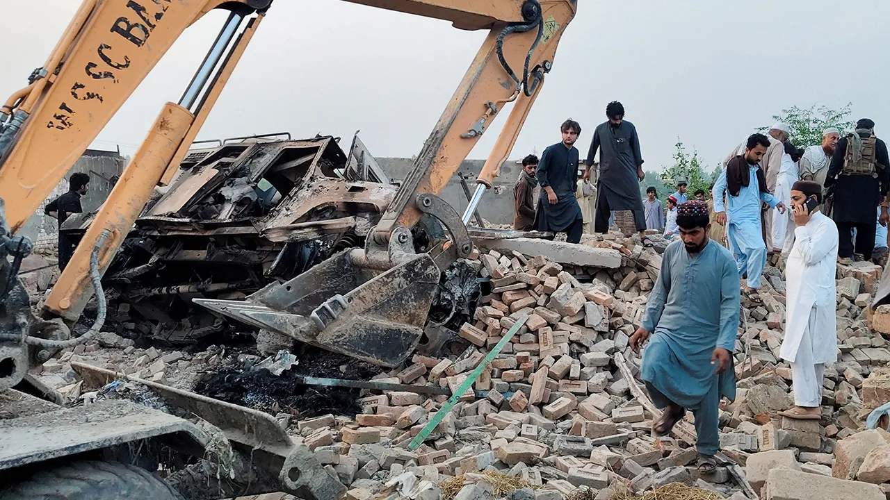 Residents gather on the rubble of a damaged police post after a car bombing in Bannu, Khyber Pakhtunkhwa province, Pakistan May 10, 2026. Picture taken with a mobile phone. REUTERS/Ehsan Khattak TPX IMAGES OF THE DAY