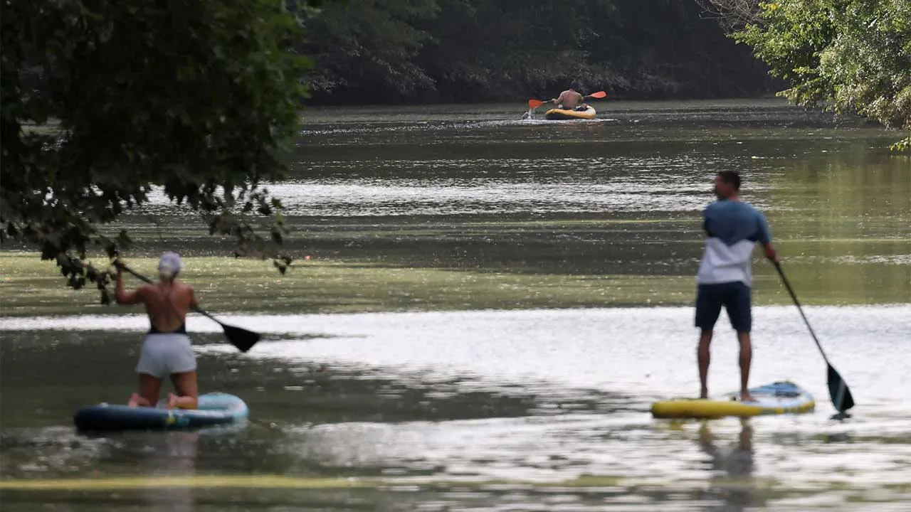 A man rows a kayak as people paddle during a heatwave affecting a large part of the country, on the Sevre Nantaise river in Vertou, near Nantes, France, June 23, 2026. REUTERS/Stephane Mahe