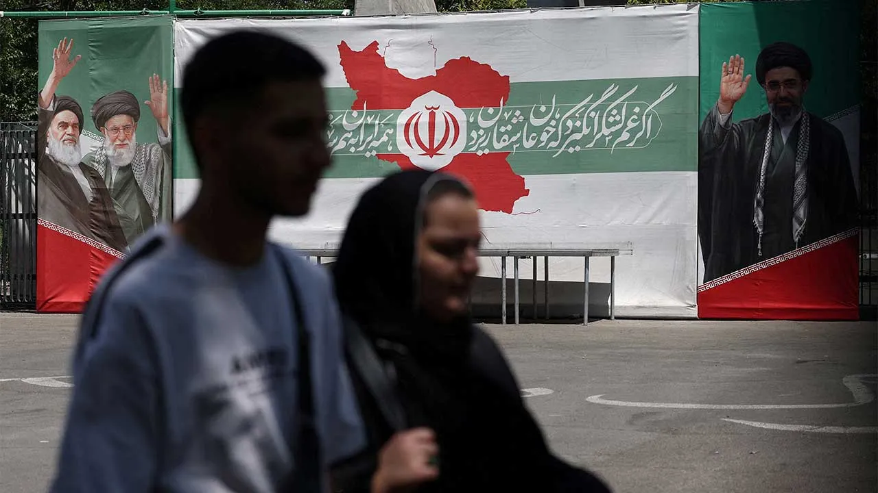 FILE PHOTO: People walk past a banner with pictures of the late leader of the Islamic Revolution, Ayatollah Ruhollah Khomeini, the late Iran's Supreme Leader Ayatollah Ali Khamenei, and Iran's Supreme Leader Mojtaba Khamenei, on a street in Tehran, Iran, June 9, 2026. Majid Asgaripour/WANA (West Asia News Agency) via REUTERS ATTENTION EDITORS - THIS PICTURE WAS PROVIDED BY A THIRD PARTY. ISRAEL OUT. NO COMMERCIAL OR EDITORIAL SALES IN ISRAEL. NO ACCESS FOR ISRAELI MEDIA. NO USE BBC PERSIAN. NO USE VOA PERSI