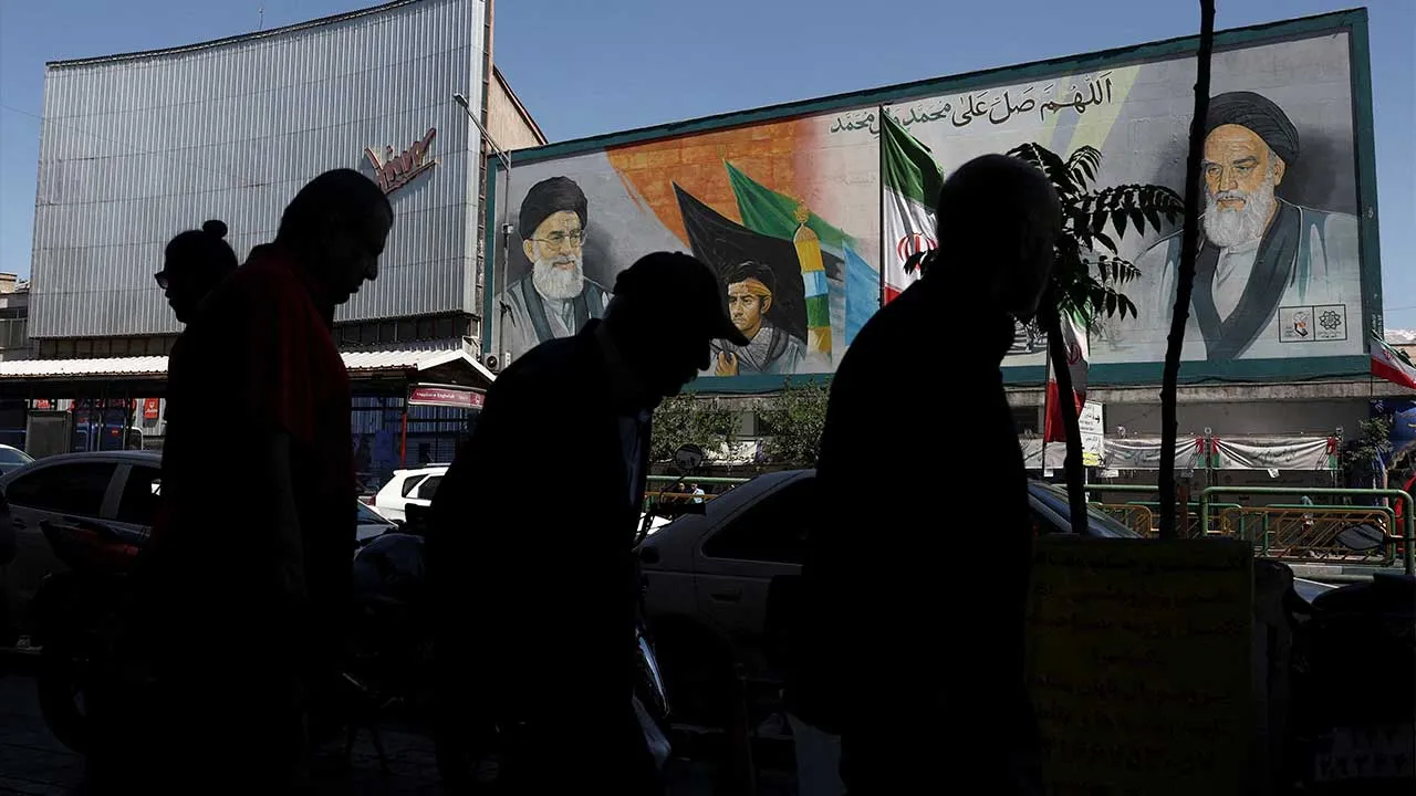 People walk past a mural depicting the late leader of the Islamic Revolution, Ayatollah Ruhollah Khomeini, and Iran's late Supreme Leader Ayatollah Ali Khamenei, in Tehran, Iran, May 25, 2026. Majid Asgaripour/WANA (West Asia News Agency) via REUTERS ATTENTION EDITORS - THIS PICTURE WAS PROVIDED BY A THIRD PARTY TPX IMAGES OF THE DAY