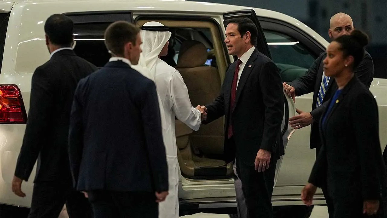 UAE Ambassador to the U.S. Yousef Al Otaiba shakes hands with U.S. Secretary of State Marco Rubio upon his arrival at Al Bateen Executive Airport to discuss the interim deal between the U.S. and Iran with Arab Gulf allies, in Abu Dhabi, United Arab Emirates, June 23, 2026. REUTERS/Eric Lee/Pool