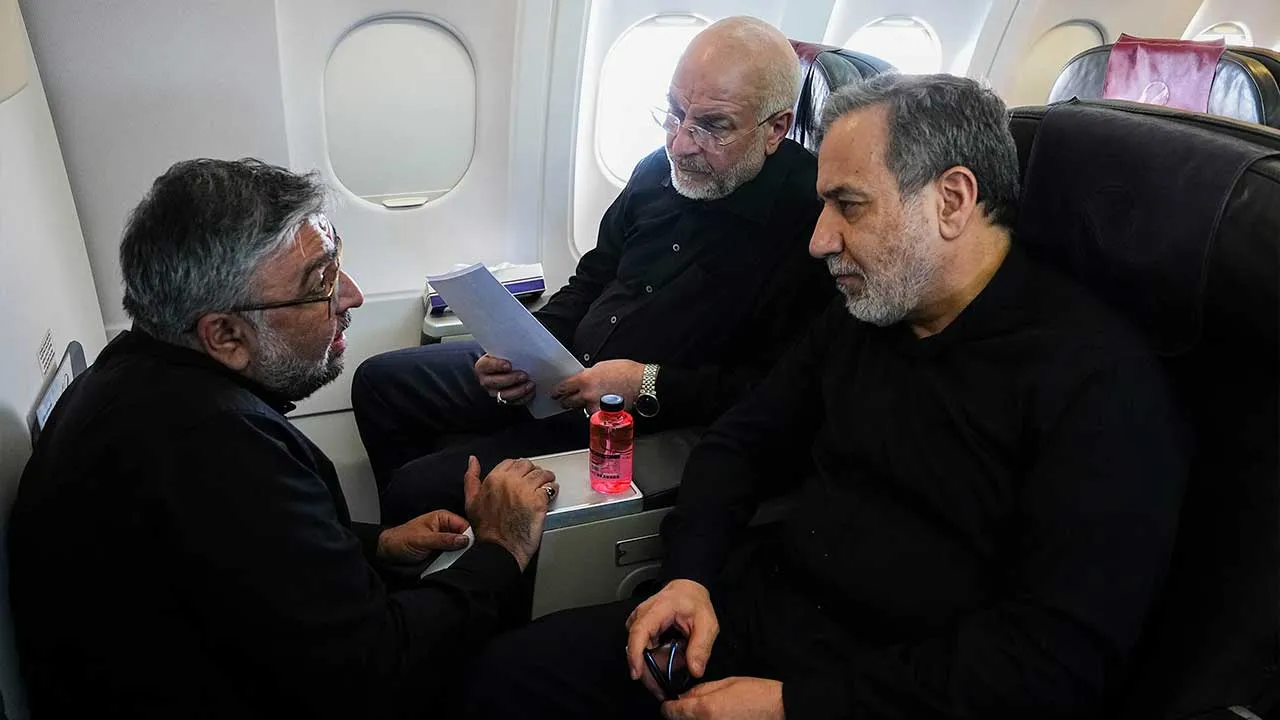 In this photo released by Islamic Consultative Assembly News Agency, ICANA, on Sunday, June 21, 2026, Iran Parliament Speaker and top negotiator Mohammad Bagher Qalibaf, center, Foreign Minister Abbas Araghchi, right, listen to Abolfazl Amouei, international affairs assistant of Qalibaf, in their flight to Switzerland to attend their talks with the U.S. delegation. (Hamed Malekpour/ICANA via AP)