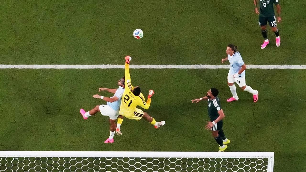Soccer Football - FIFA World Cup 2026 - Group H - Saudi Arabia v Uruguay - Miami Stadium, Miami Gardens, Florida, U.S. - June 15, 2026 Saudi Arabia's Mohammed Al-Owais makes a save from Uruguay's Sebastian Caceres REUTERS/Amanda Perobelli