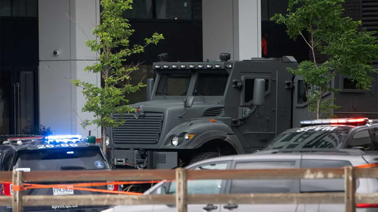 Police vehicles at the scene, following a fatal shooting in which a police officer was killed in the Cote-des-Neiges neighbourhood, Montreal police say, in Montreal, Quebec, Canada, June 22, 2026. REUTERS/Peter McCabe
