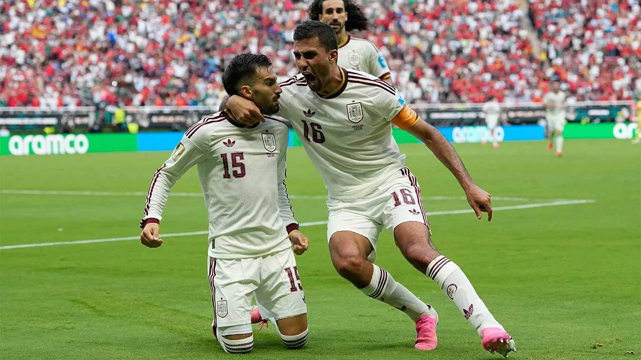 Spain's Alex Baena, left, is congratulated after scoring his side's opening goal by Rodri during the World Cup Group H soccer match between Uruguay and Spain in Zapopan, near Guadalajara, Mexico, Friday, June 26, 2026. (AP Photo/Natacha Pisarenko)