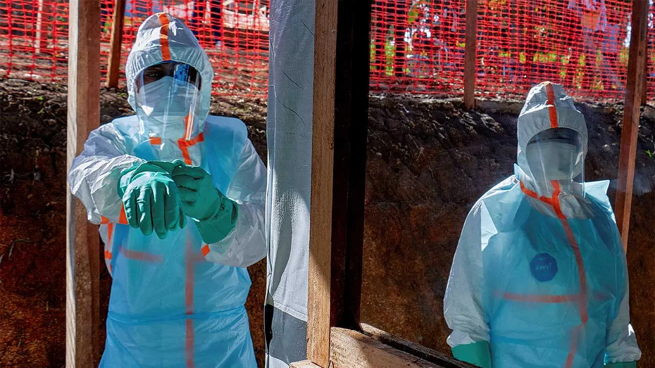 Health workers get dressed in personal protective equipment (PPE) at the Evangelical Medical Center, one of the facilities at the forefront of the response to the Ebola outbreak, as agencies intensify efforts to contain a new Ebola outbreak caused by the Bundibugyo virus strain, in Bunia, Ituri province, Democratic Republic of Congo, May 31, 2026. REUTERS/Gradel Muyisa Mumbere TPX IMAGES OF THE DAY