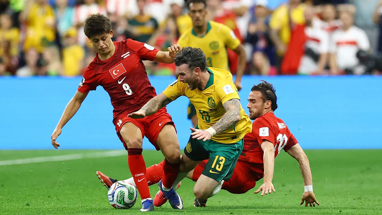 Soccer Football - FIFA World Cup 2026 - Group D - Australia v Turkey - BC Place, Vancouver, Canada - June 13, 2026 Turkey's Arda Guler in action with Australia's Aiden O'Neill REUTERS/Albert Gea