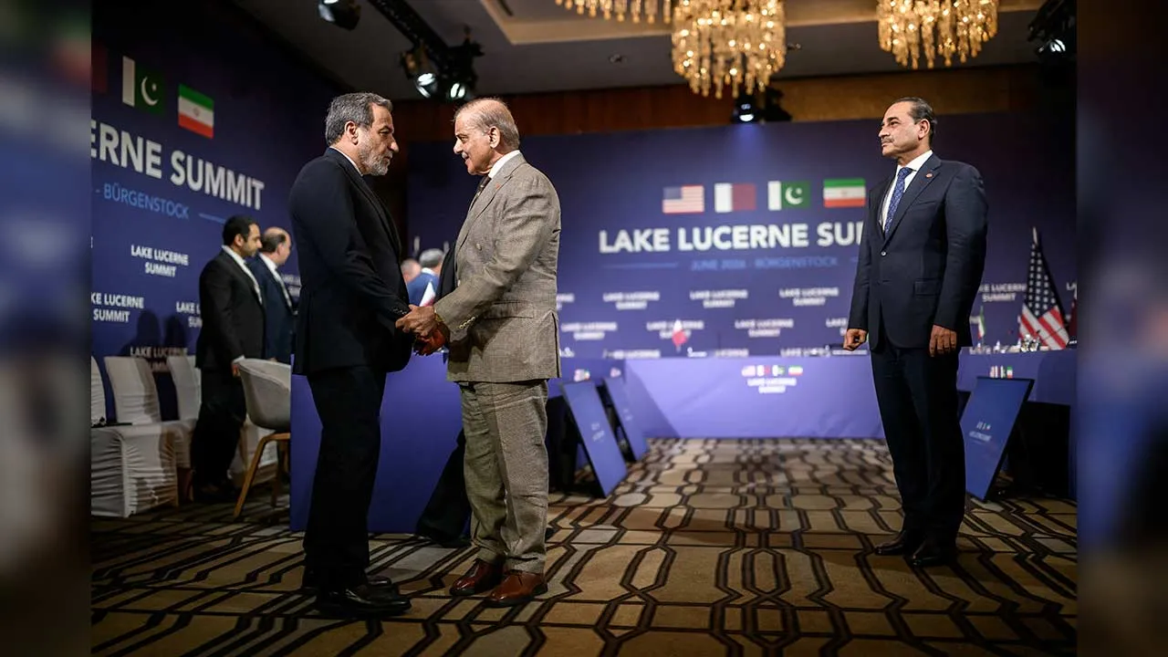 Iran's Foreign Minister Abbas Araqchi shakes hands with Pakistan's Prime Minister Shehbaz Sharif next to Pakistan's Chief of Army Staff Field Marshal Asim Munir prior to a quadrilateral meeting between the United States, Iran, Pakistan and Qatar at the Burgenstock luxury hotel complex overlooking Lake Lucerne, Switzerland, on June 21, 2026. Fabrice Coffrini/Pool via REUTERS