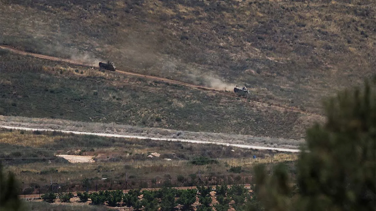 Armoured personnel carriers (APCs) drive on the Lebanese side of the Israel-Lebanon border, as seen from northern Israel, June 17, 2026. REUTERS/Shir Torem