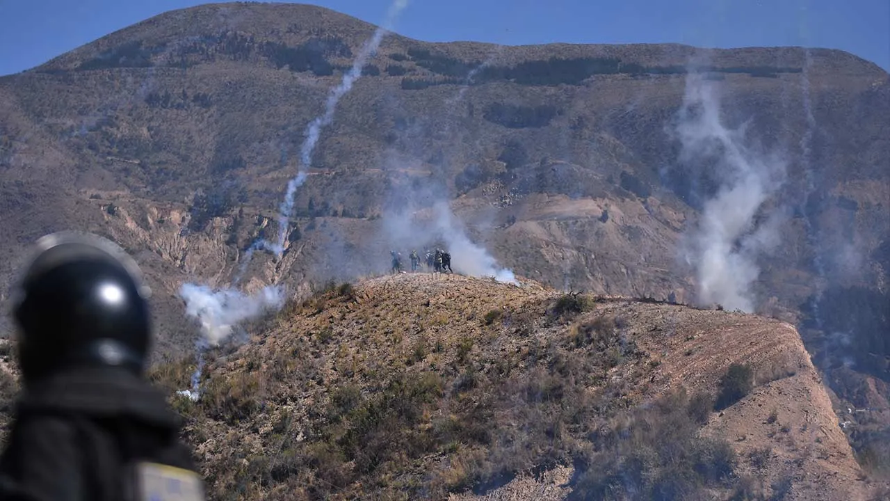 Police fire tear gas at anti-government protesters blocking a road in Llavini, outside Cochabamba, Bolivia, Sunday, June 21, 2026. (AP Photo/Dico Soliz)