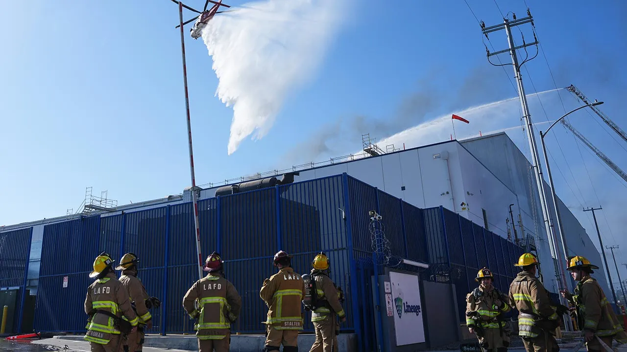 Water is dropped by helicopter at a warehouse fire in the Boyle Heights section of Los Angeles on Wednesday, June 17, 2026. (AP Photo/Jae C. Hong)