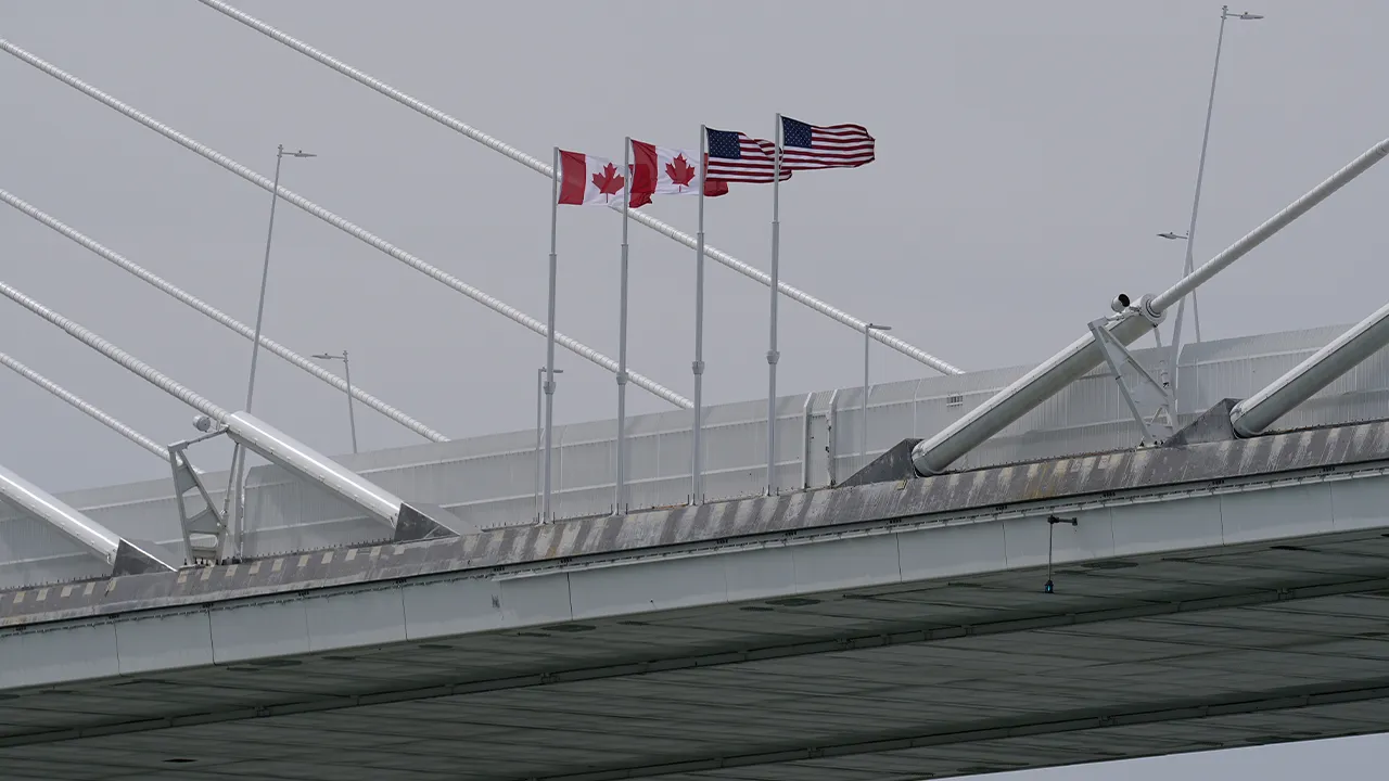FILE - Canadian and American flags are shown on the Gordie Howe Bridge under construction between Windsor, Ontario and Detroit, May 22, 2026. (AP Photo/Paul Sancya, File)