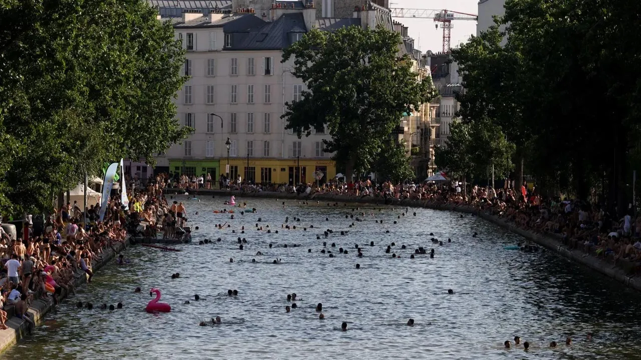 People swim in Canal Saint-Martin after public swimming was permitted in certain areas due to high temperatures, France, June 26, 2026. / Reuters
