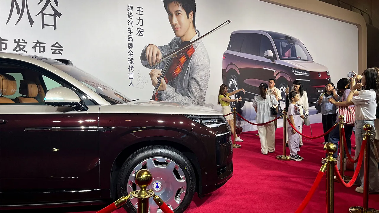 People stand near the newly launched N9 electric vehicle (EV) under BYD's premium brand Denza, displayed at a launch event in Guangzhou, Guangdong province, China May 18, 2026. REUTERS/Zoey Zhang/File Photo