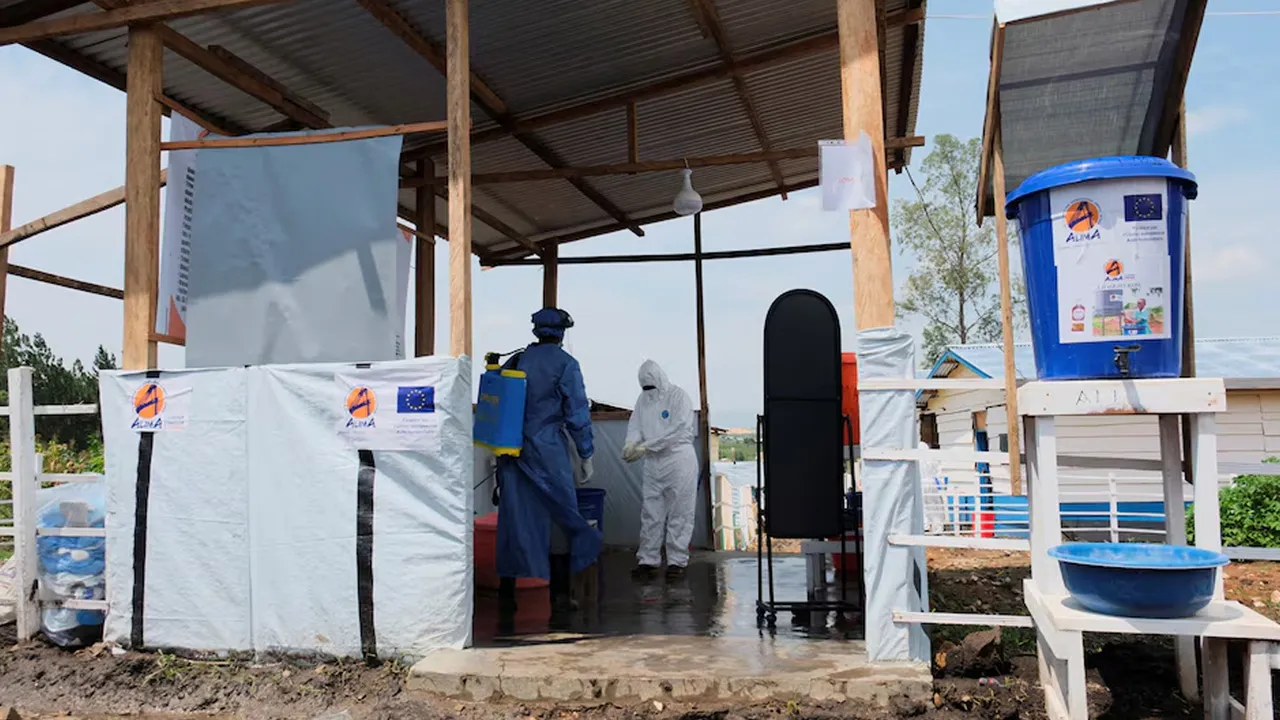 Medical workers dressed in personal protective equipment (PPE) disinfect and wash their hands at an Ebola treatment centre during a ceremony to present recovery certificates to patients at the Rwambara General Reference Hospital in Bunia, eastern Democratic Republic of Congo, June 16, 2026. REUTERS