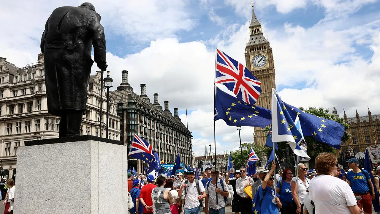 People walk past the Elizabeth Tower, commonly known as Big Ben, during the National Rejoin March IV organised by National Rejoin March (NRM), marking ten years since Britain voted to leave the European Union in 2016 and calling for closer cooperation between Britain and Europe, in London, Britain, June 20, 2026. REUTERS/Jack Taylor