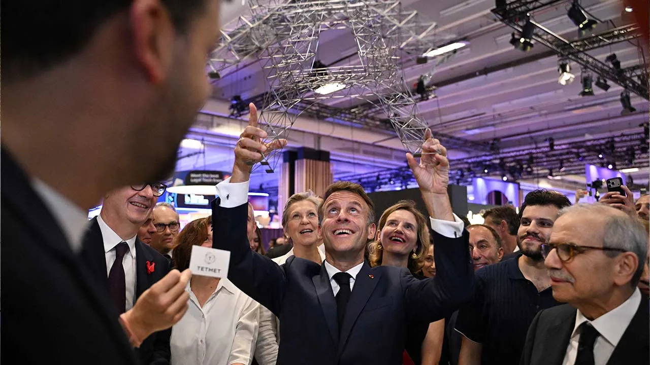 France’s President Emmanuel Macron holds a replica of the Eiffel Tower as Lebanon's Prime Minister Nawaf Salam stands beside him at the Viva Technology (VivaTech) trade fair, in Paris, France, June 18, 2026. Emma Da Silva/Pool via REUTERS