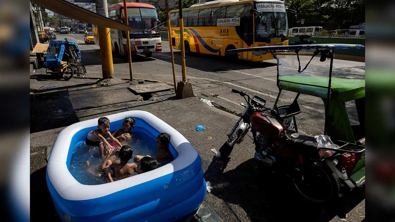 FILE PHOTO: Children swim in an inflatable pool during a hot day in Manila, Philippines, April 29, 2024. REUTERS/Eloisa Lopez/File Photo