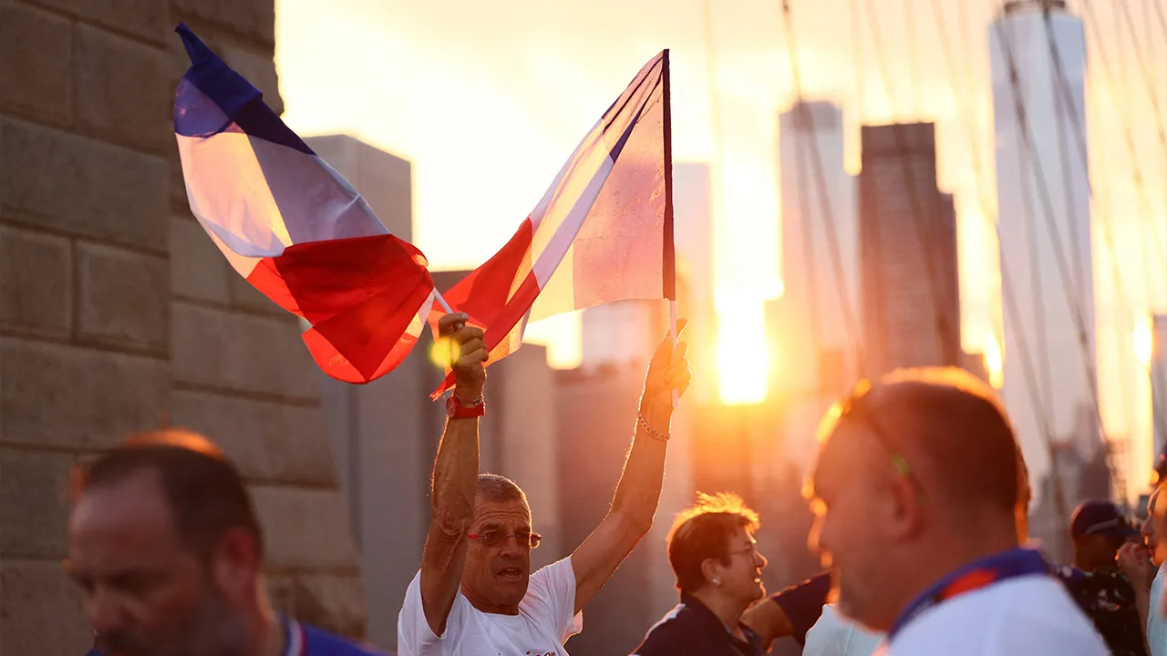 Soccer Football - FIFA World Cup 2026 - France fans walk across Brooklyn Bridge - Brooklyn Bridge, New York City, New York, U.S. - June 29, 2026 A France fan with a flag as they walk across Brooklyn Bridge ahead of their round of 32 match tomorrow against Sweden IMAGN IMAGES via Reuters/Caean Couto