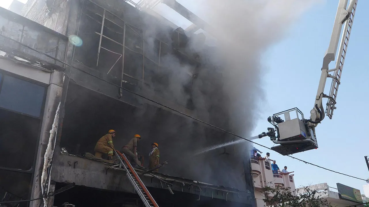 Firefighters douse a deadly fire at a coaching centre in Lucknow, India, June 22, 2026. REUTERS/STRINGER