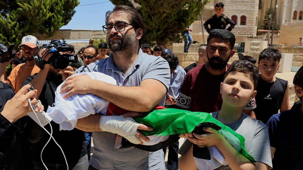 Father and brother of Sam Abu Haykal, a 7-month-old Palestinian child who was killed by Israeli soldiers, carry his body during his funeral in Hebron in the Israeli-occupied West Bank, June 6, 2026. REUTERS/Mussa Qawasma