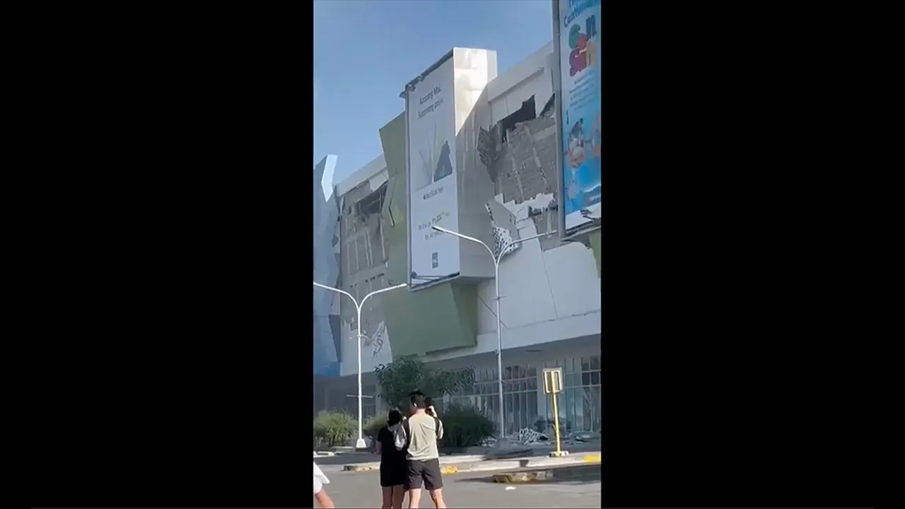 This image from a video shows people gathered outside a damaged building after a powerful earthquake in General Santos city on the island of Mindanao, Philippines Monday, June 8, 2026. (Ernesto Torres Jr via AP)