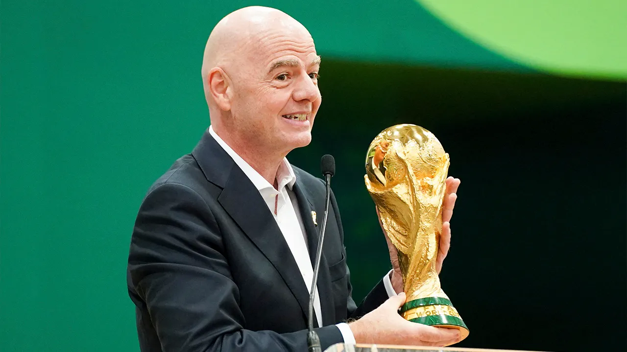 Jun 1, 2026; Dallas, Texas, USA; FIFA President Gianni Infantino holds the World Cup trophy while he speaks during the grand opening of the 2026 FIFA World Cup international broadcast center at Kay Bailey Hutchison Convention Center. Mandatory Credit: Raymond Carlin III-Imagn Images_REUTERS