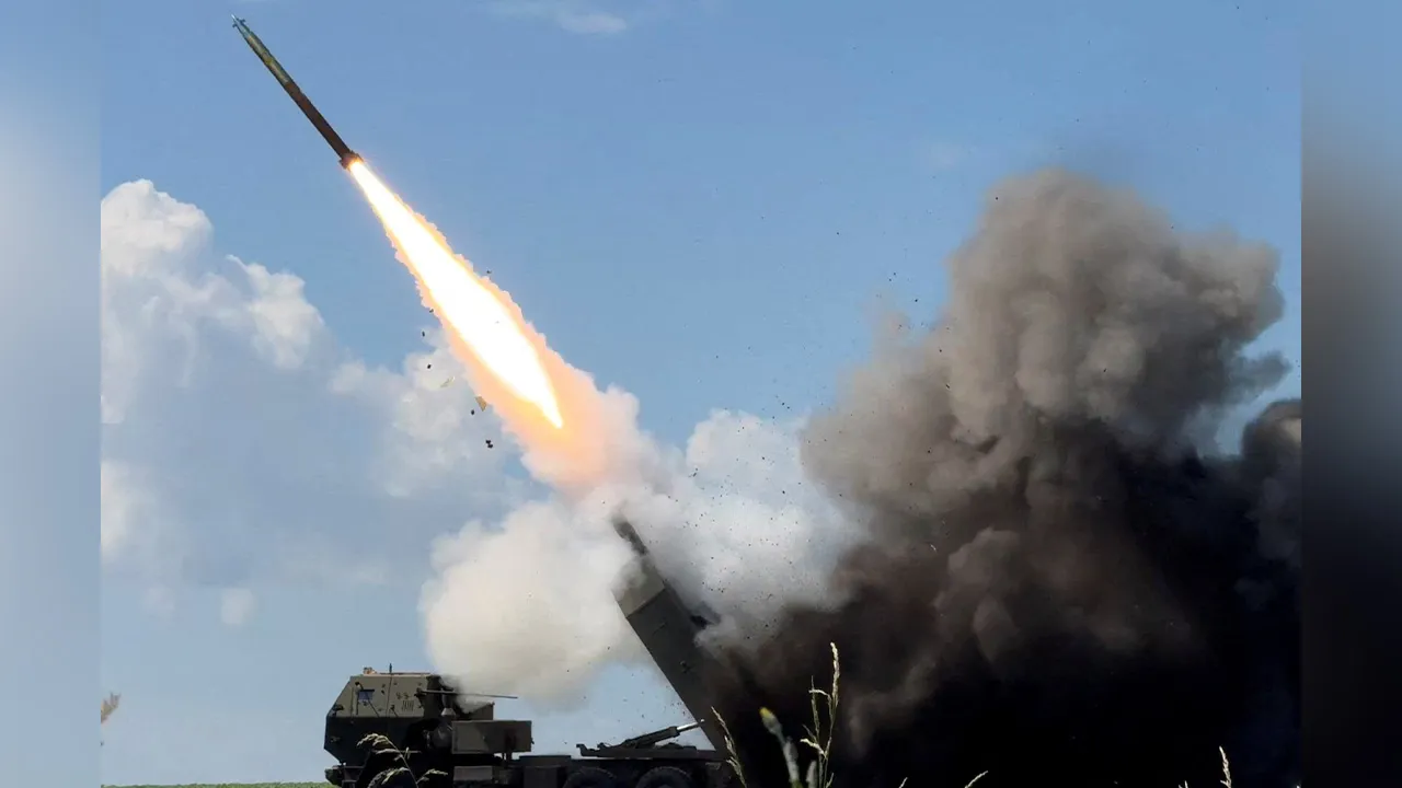 Ukrainian servicemen fire a High Mobility Artillery Rocket System (HIMARS) towards Russian troops, amid Russia's attack on Ukrai