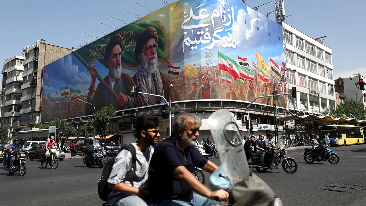 People ride past a billboard depicting the late leader of the Islamic Revolution, Ayatollah Ruhollah Khomeini, and the late Iran's Supreme Leader Ayatollah Ali Khamenei, on a street in Tehran, Iran, June 10, 2026. Majid Asgaripour/WANA (West Asia News Agency) via REUTERS
