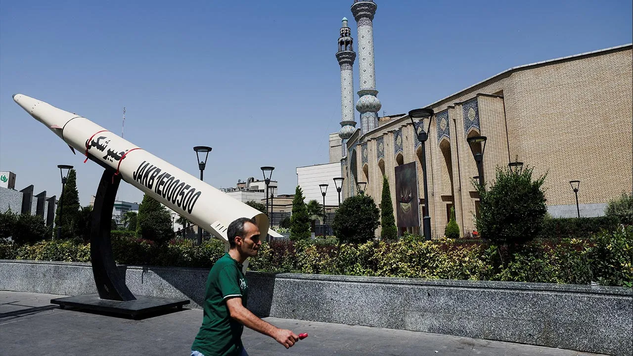 A man walks next to a symbolic mock-up of an Iranian missile, on a street in Tehran, Iran, June 11, 2026. Majid Asgaripour/WANA (West Asia News Agency) via REUTERS