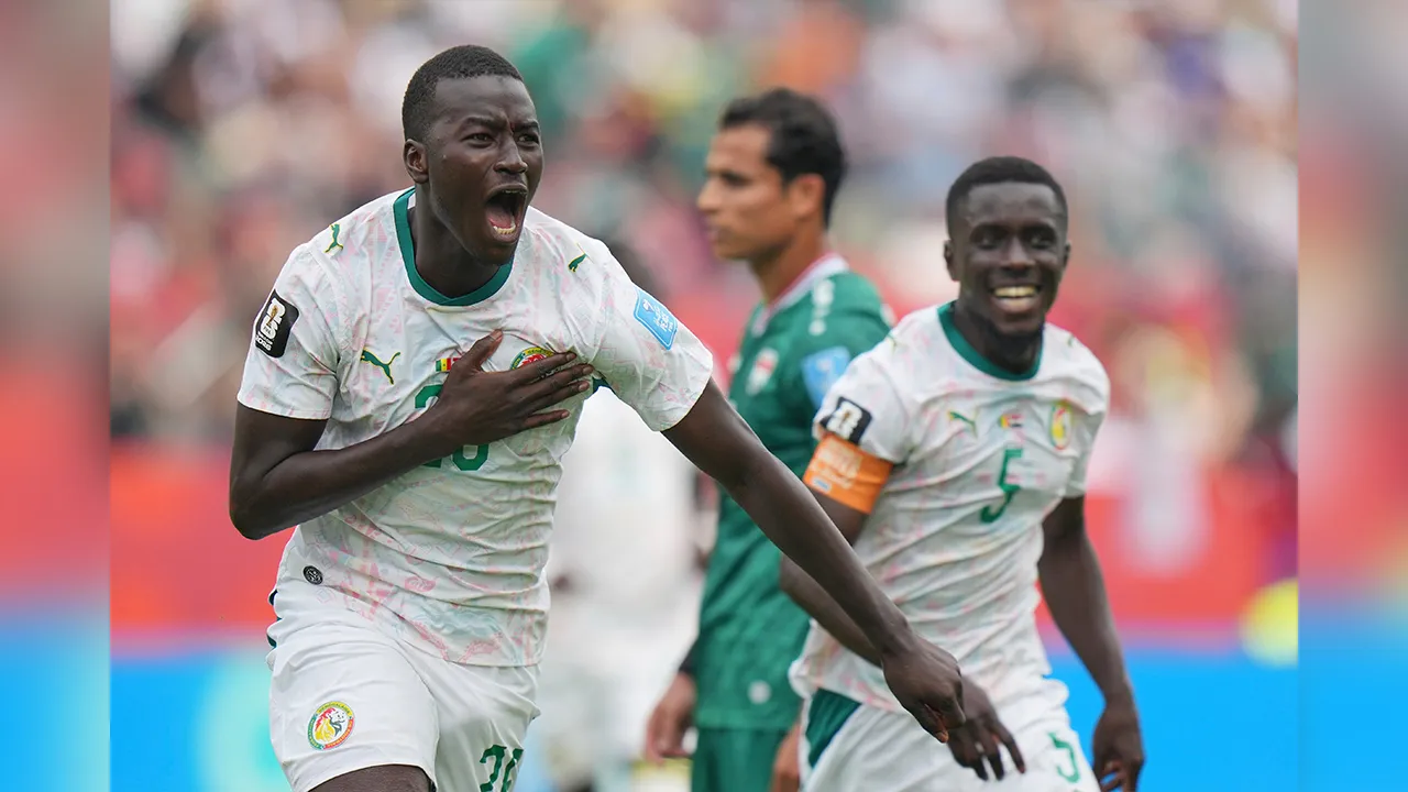 Senegal's Pape Gueye (26) celebrates their third goal during the World Cup Group I soccer match between Senegal and Iraq in Toronto, Friday, June 26, 2026. (AP Photo/Stephanie Scarbrough)