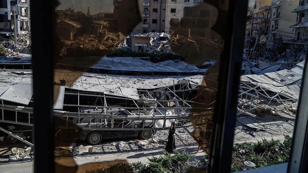 A woman walks past rubble at the site of an Israeli strike following a deal between the U.S. and Iran in Tyre, southern Lebanon, June 16, 2026. REUTERS/Zohra Bensemra
