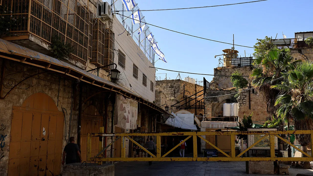 Israeli flags in the old city of Hebron in the Israeli-occupied West Bank June 17, 2026. REUTERS/Mussa Qawasma