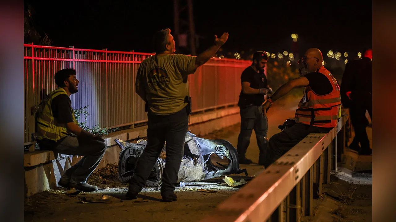 Israeli security and rescue personnel work next to a part of a projectile following a missile attack from Iran towards Israel in northern Israel, June 8, 2026. REUTERS/Shir Torem