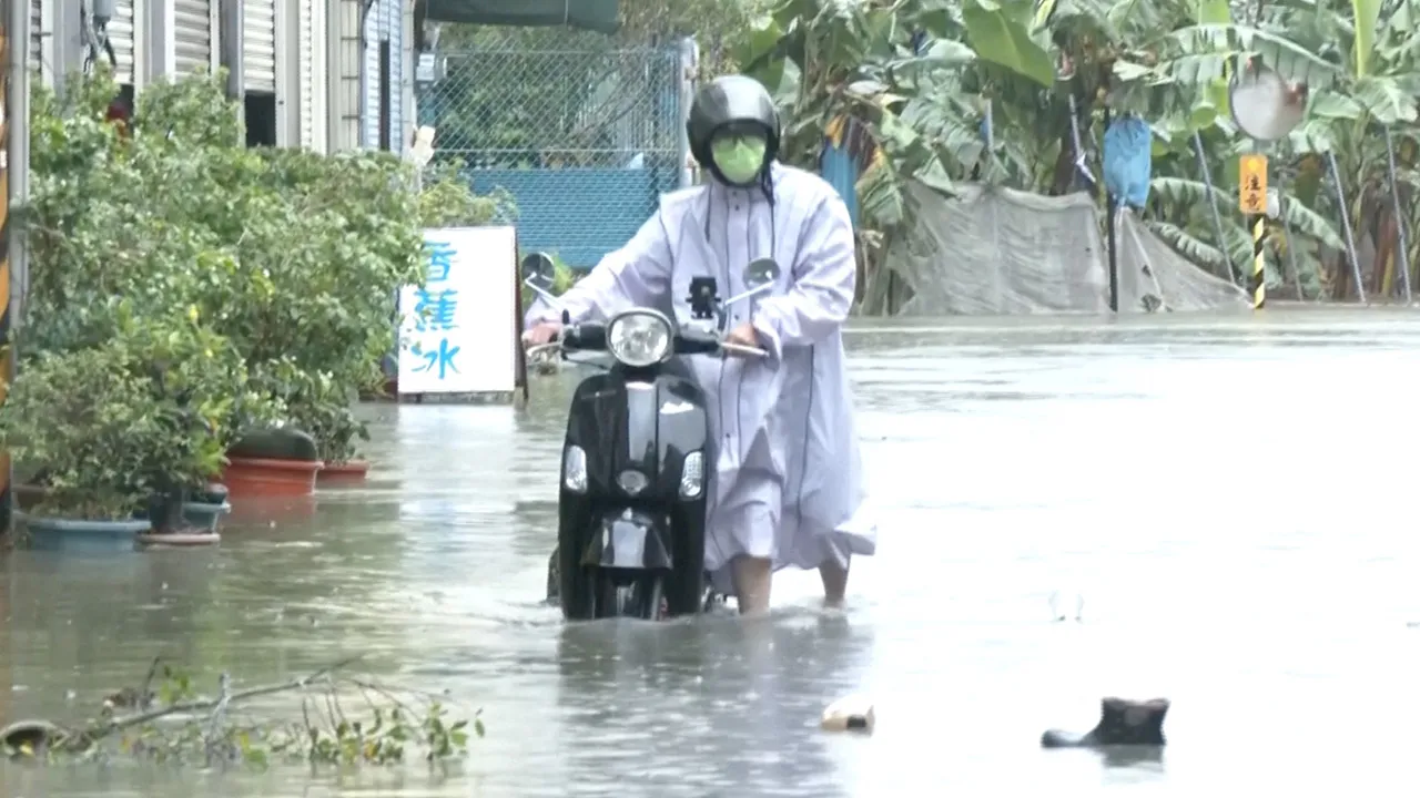 A man with a scooter moves in the floodwater during heavy rains caused by the nearby passing of typhoon Mekkhala, as it heads towards Japan, in Kaohsiung, Taiwan, June 25, 2026. CTS via REUTERS TV/via REUTERS