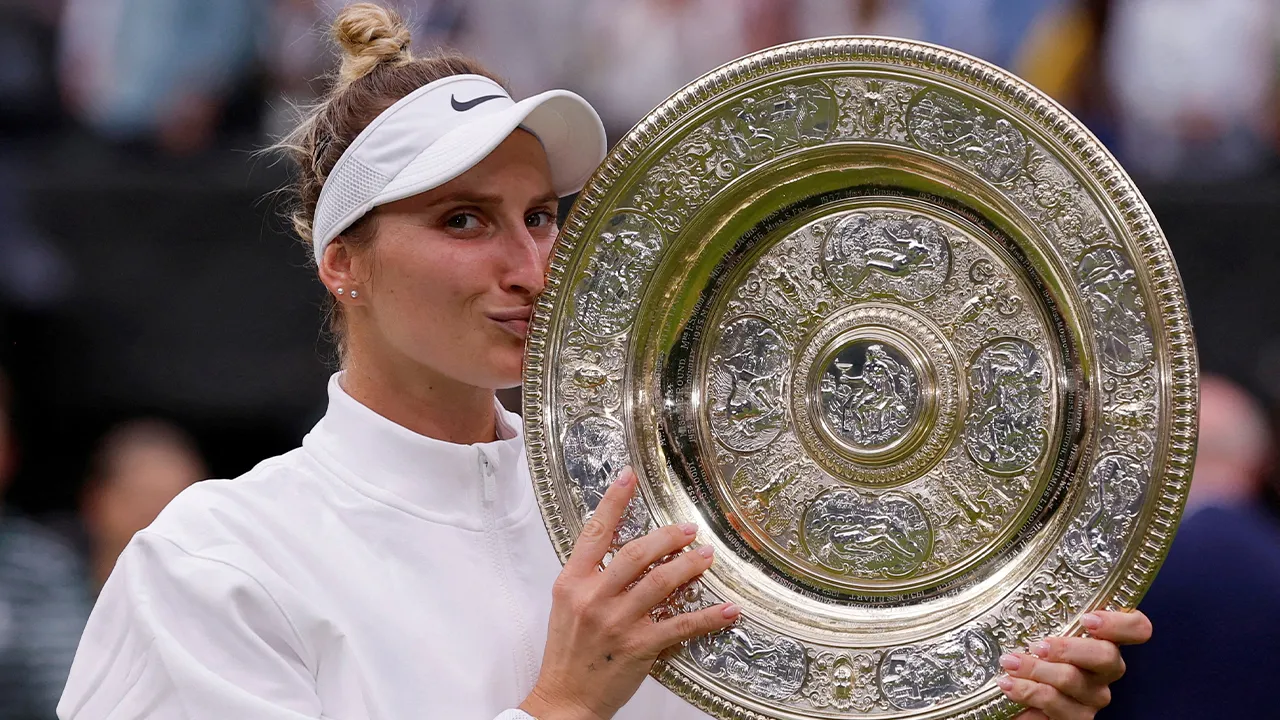 FILE PHOTO: Tennis - Wimbledon - All England Lawn Tennis and Croquet Club, London, Britain - July 15, 2023 Czech Republic's Marketa Vondrousova celebrates with the trophy winning her final match against Tunisia’s Ons Jabeur REUTERS/Andrew Couldridge/File Photo
