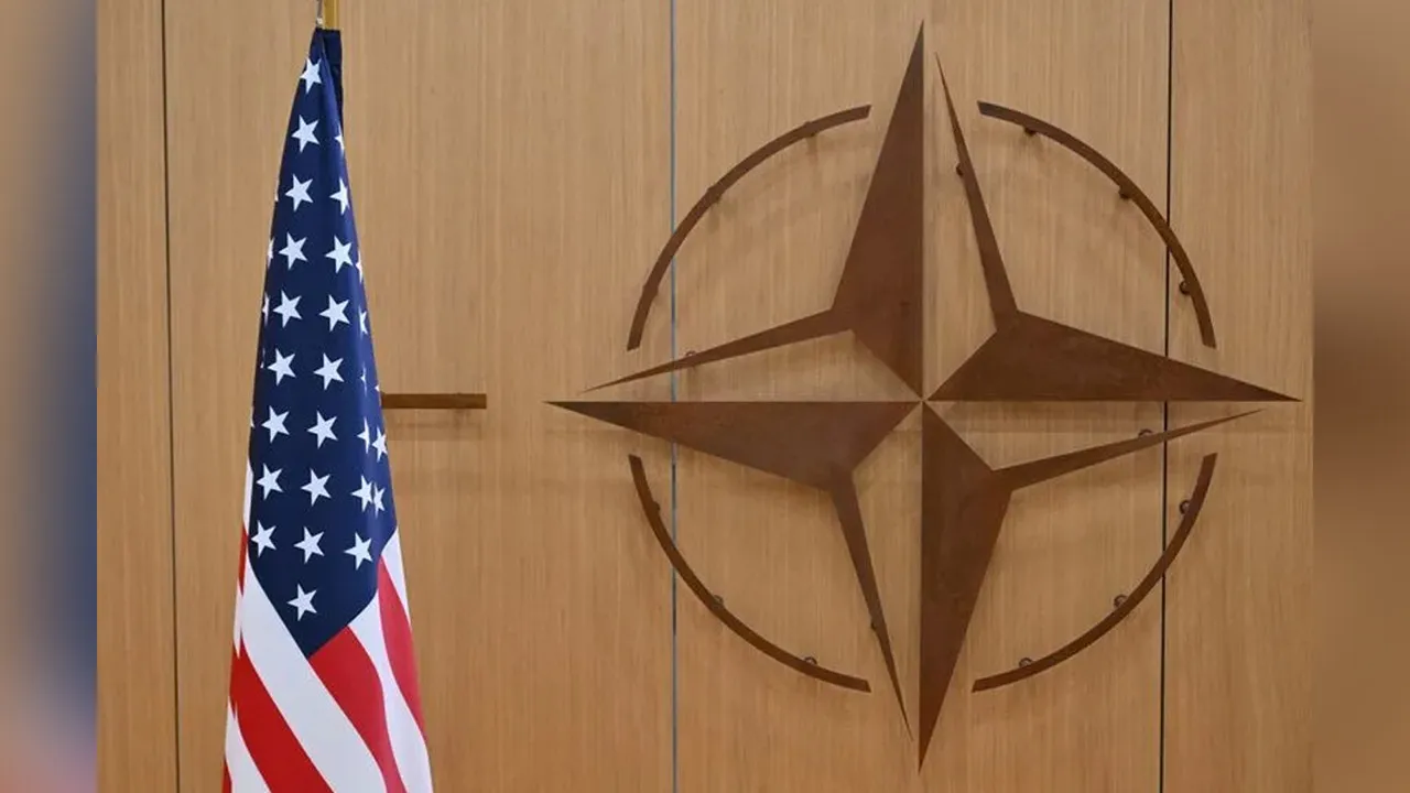 This photo shows the logo of the North Atlantic Treaty Organisation (NATO) and the US flag at NATO headquarters in Brussels, Belgium on February 17, 2025. NICOLAS TUCAT/Pool via REUTERS