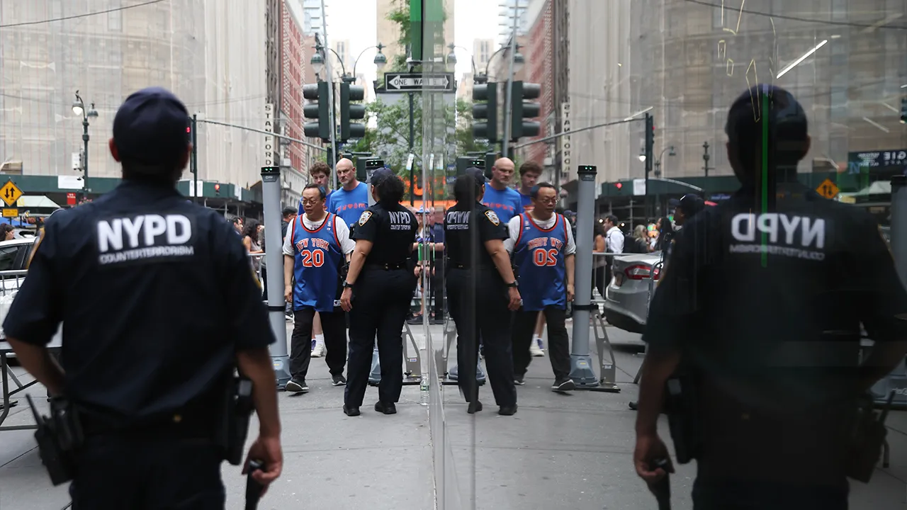 Fans pass a security checkpoint on Sixth Avenue outside of Madison Square Garden ahead of Game 4 of the NBA Finals between the New York Knicks and San Antonio Spurs, Wednesday, June 10, 2026, in New York. (AP Photo/Heather Khalifa)