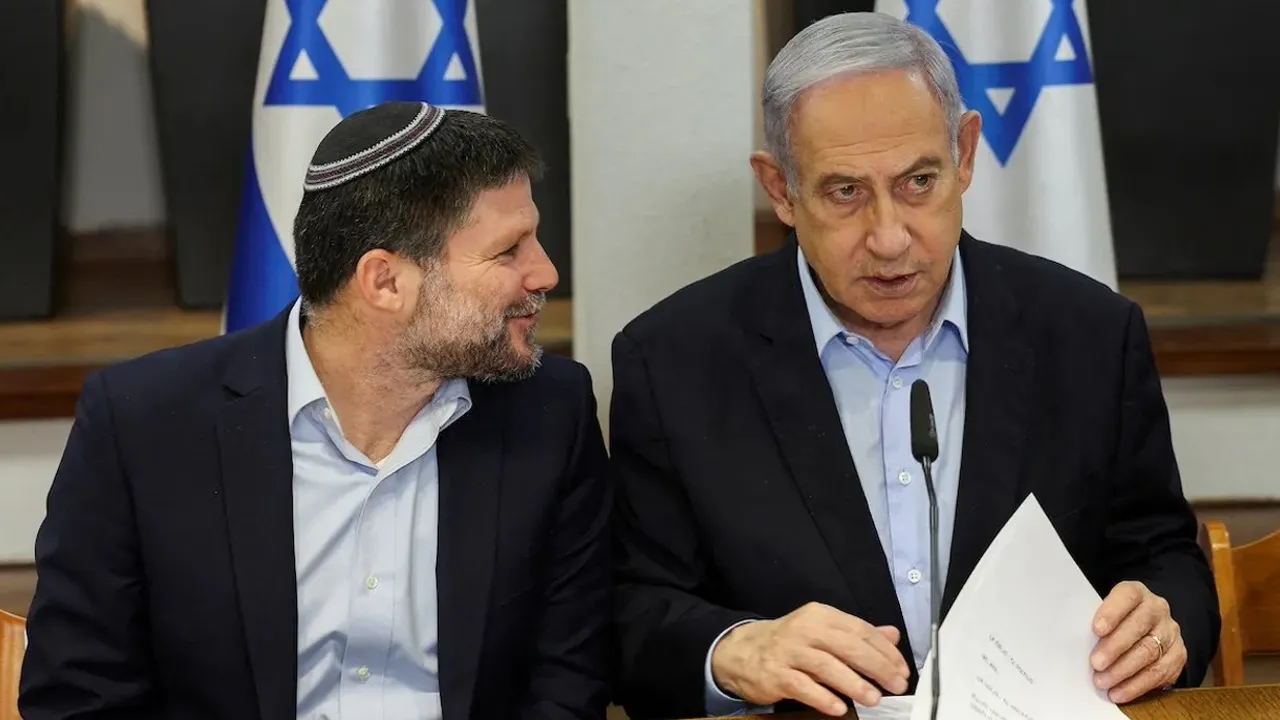 Israeli Prime Minister Benjamin Netanyahu speaks with Minister of Finance Bezalel Smotrich during the weekly cabinet meeting at the Defence Ministry in Tel Aviv, Israel, January 7, 2024. REUTERS/Ronen Zvulun/Pool