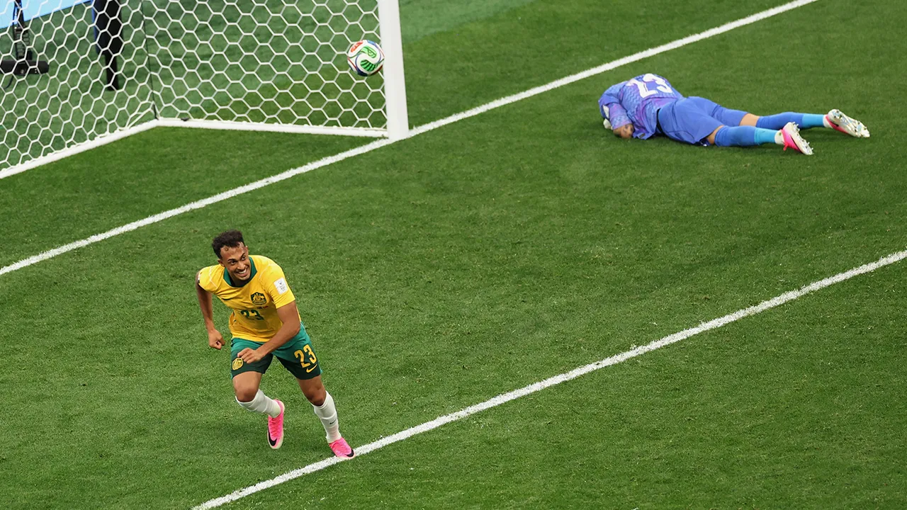 Australia's Nishan Velupillay (23) celebrates after his teammate Australia's Connor Metcalfe (8) scored on Turkey goalkeeper Ugurcan Cakir (23) during the World Cup Group D soccer match in Vancouver, British Columbia, Saturday, June 13, 2026. (AP Photo/Emma Peterson)