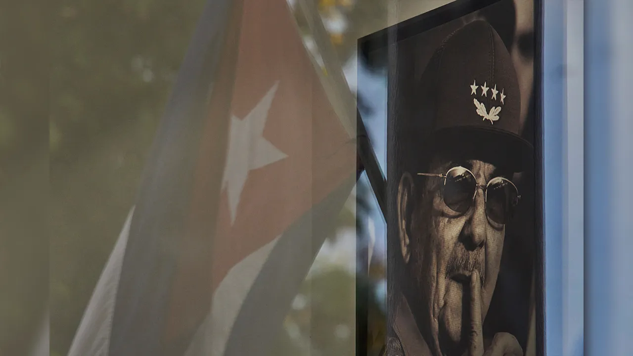 A photo of Raul Castro is seen with a reflected Cuban flag in a state store in Havana, Cuba, Tuesday, June 2, 2026. (AP Photo/Ramon Espinosa)