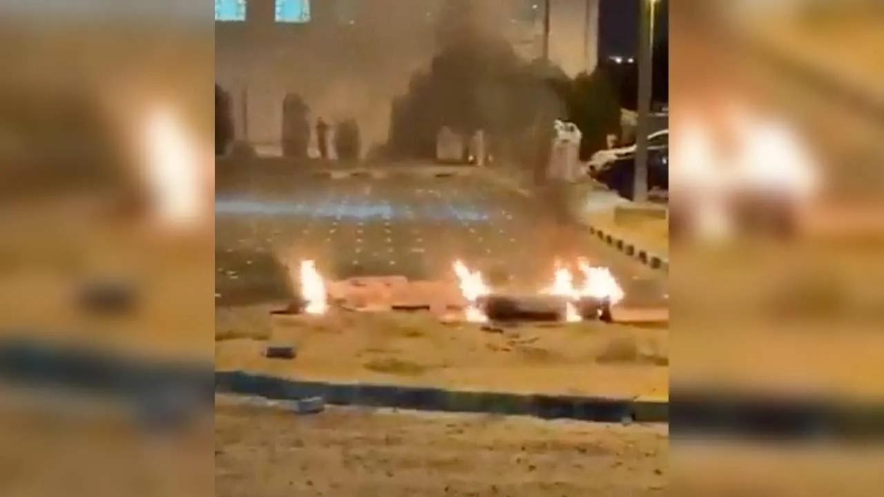 Debris burns in Kuwait following reports that air defences intercepted missile and drone attacks