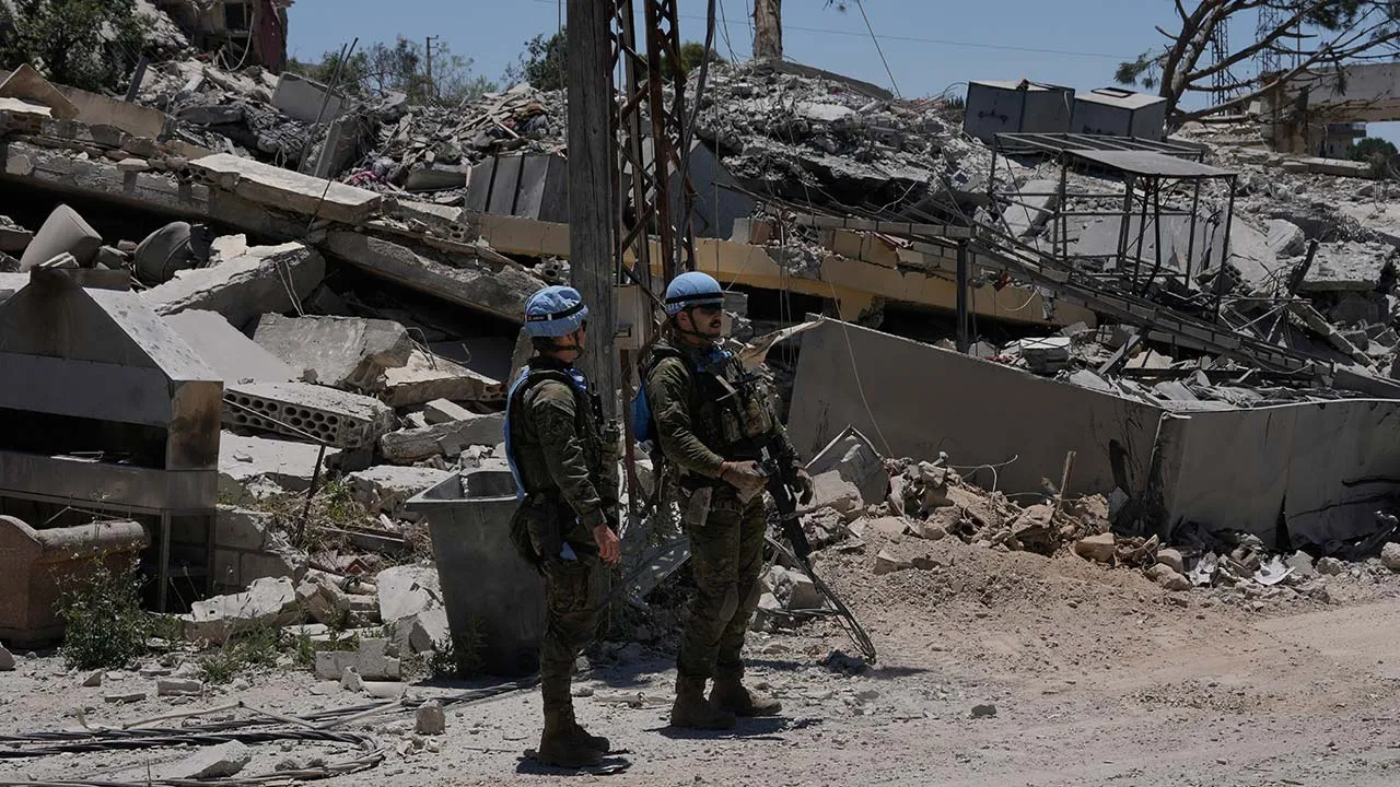 Spanish UN peacekeepers deploy in front of houses that were destroyed in the recent clashes between Hezbollah fighters and Israeli troops in Dibbine village, southeast Lebanon, Friday, June 5, 2026, a day after Israeli forces withdrew. (AP Photo/Hussein Malla)