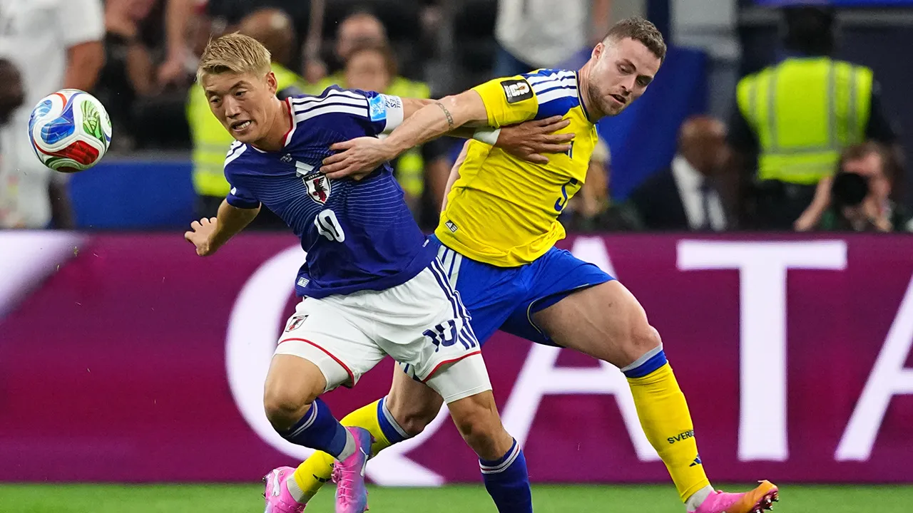 Japan's Ritsu Doan, left, and Sweden's Gabriel Gudmundsson battle for the ball during the World Cup Group F soccer match in Arlington, Texas, near Dallas, Thursday, June 25, 2026. (AP Photo/Julio Cortez)