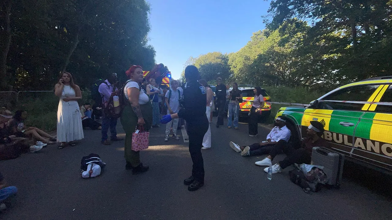 Emergency service workers and people gather near the scene of a collision involving two trains near Bedford, Britain, June 19, 2026. Picture taken with a mobile phone. Dr Pete Knapp/via REUTERS