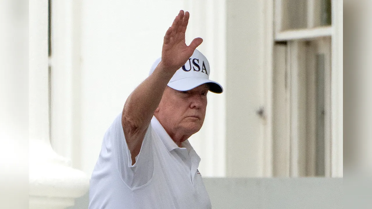 President Donald Trump waves as he walks into the North Portico at the White House, Saturday, June 27, 2026, in Washington. (AP Photo/Mark Schiefelbein)