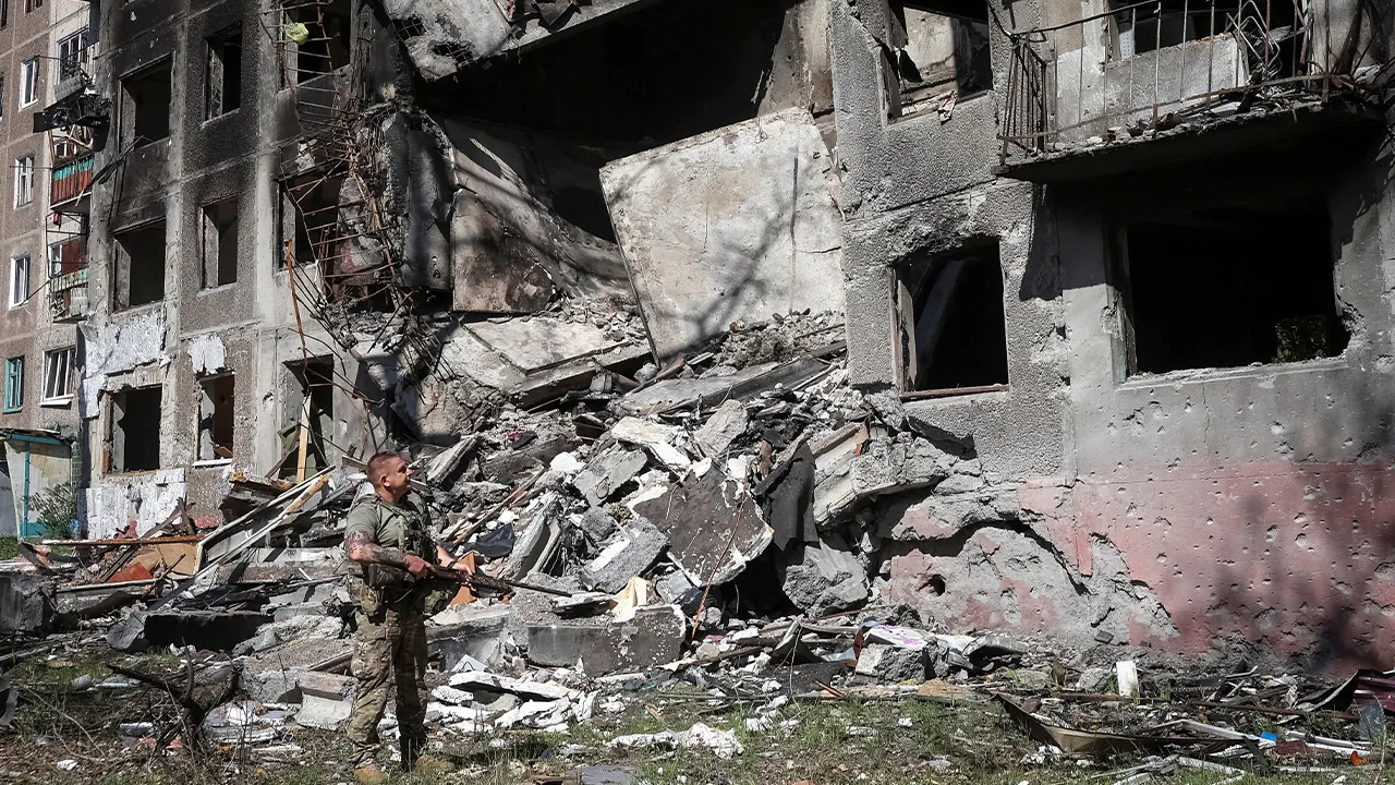 A member of the White Angel unit of Ukrainian police officers, who evacuate people from the frontline towns and villages, checks an area for residents, amid Russia's attack on Ukraine, in the frontline town of Druzhkivka, in Donetsk region, Ukraine June 22, 2026. REUTERS/Anatolii Stepanov