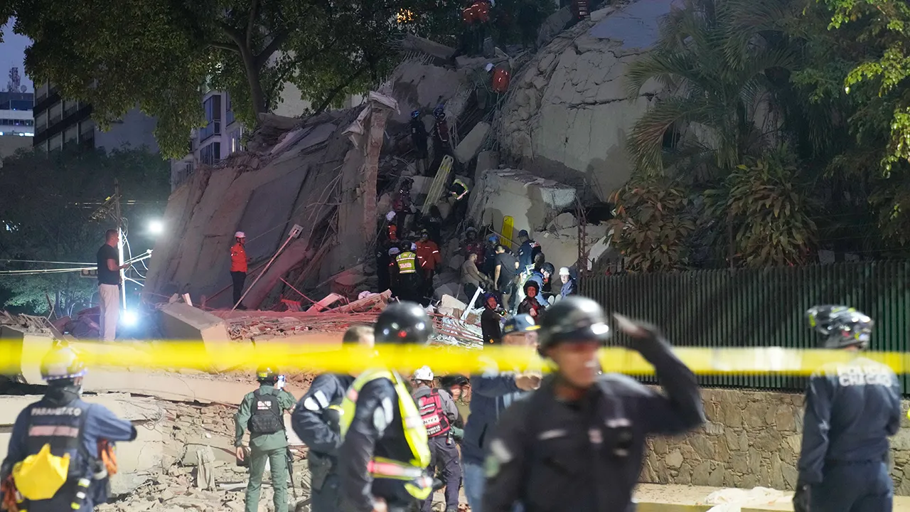 Rescue workers search for survivors at a collapsed building after an earthquake in Caracas, Venezuela, Wednesday, June 24, 2026. (AP Photo/Ariana Cubillos)
