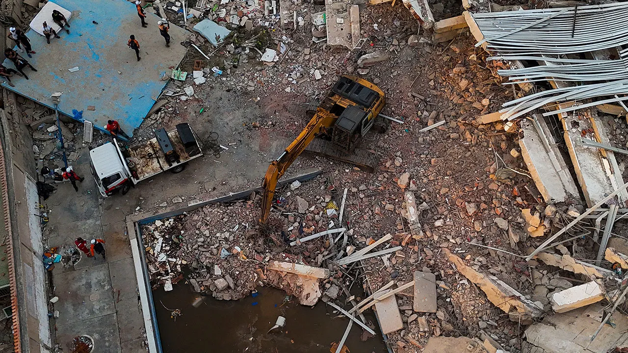 This aerial view shows workers searching through destroyed buildings in Caraballeda, La Guaira State, Venezuela, on Monday, June 29, 2026, following two major earthquakes. (Miguel Medina/Pool Photo via AP)