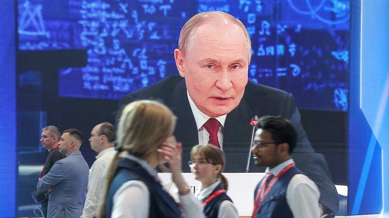 Participants walk past a screen showing Russia's President Vladimir Putin at the venue of the St. Petersburg International Economic Forum (SPIEF) in Saint Petersburg, Russia June 3, 2026. REUTERS/Anastasia Barashkova